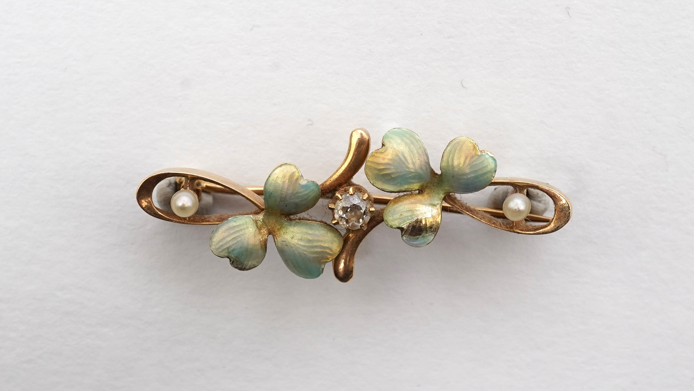 An Art Nouveau gold, enamel, seed pearl and diamond bar brooch, early 20th century